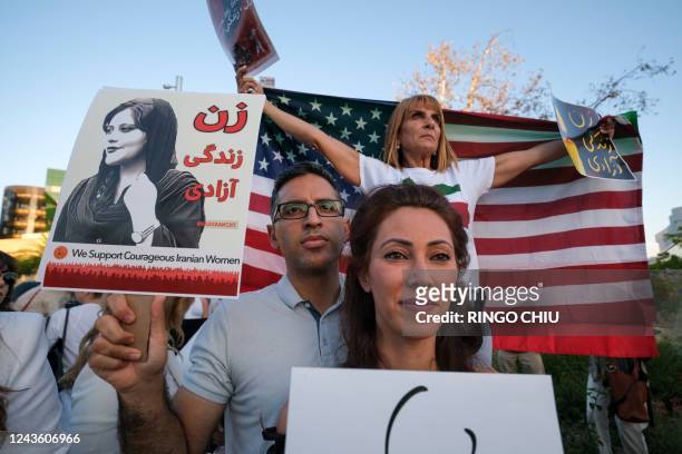 People take part in a candlelight vigil for Mahsa Amini who died in custody of Iran's morality police, in Los Angeles, California, September 29,...