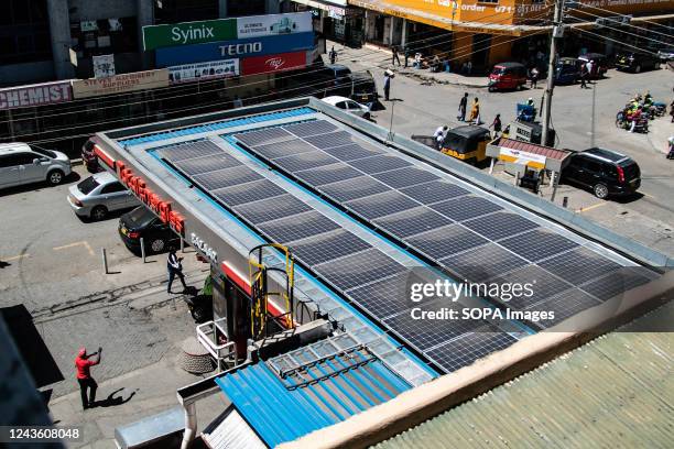 Solar panels are seen on the roof of Total Energies Gas Station in Nakuru Town. To limit global warming to below 1.5 degrees Celcius, the world is...