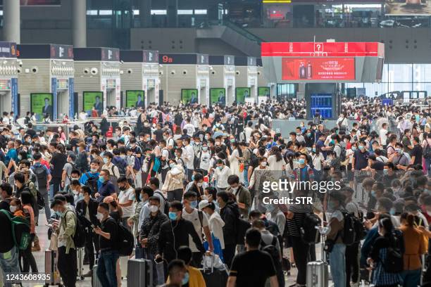 Passengers crowd Zhengzhou East Railway Station one day ahead of the National Day holidays, in Zhengzhou in China's central Henan province on...