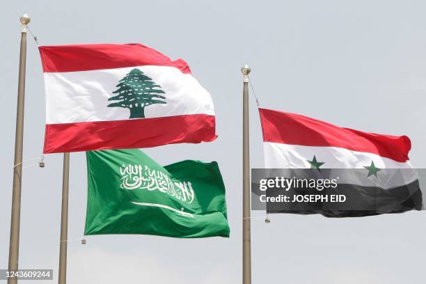 Saudi , Syrian and Lebanese flags fly as Syrian President Bashar al-Assad and Saudi King Abdullah bin Abdel Aziz arrive at Rafiq Hariri international...