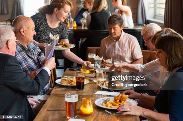 waitress bringing pub meals - pub food stock pictures, royalty-free photos & images