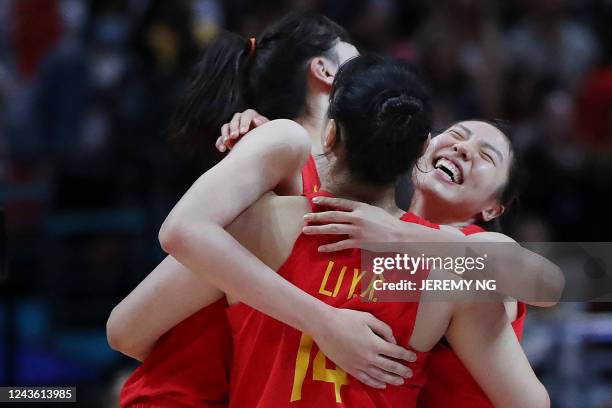 Team China celebrate after their victory in the Women's Basketball World Cup semi-final game between Australia and China in Sydney on September 30,...