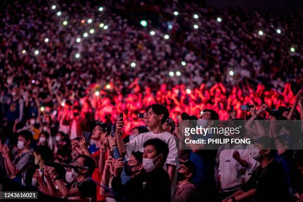 People watch the NBA Japan Games 2022 pre-season basketball game between the Golden State Warriors and the Washington Wizards at the Saitama Super...