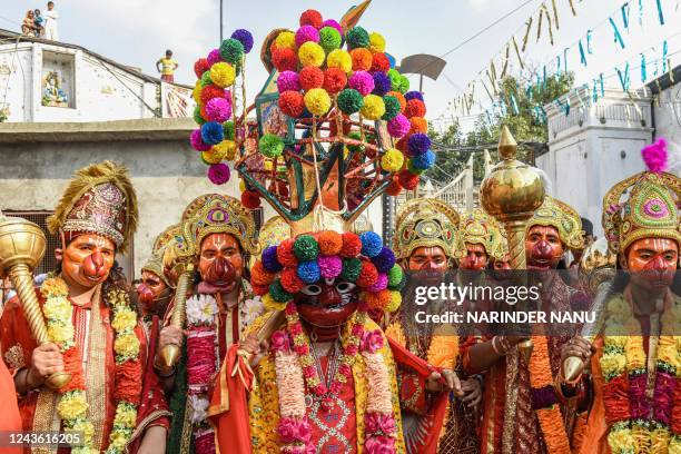 Artists dress as Hindu deity lord Hanuman as they take part in a religious procession during the Navratri celebrations in Amritsar on September 30,...