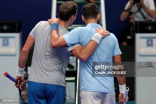 Canada's Vasek Pospisil and Serbia's Novak Djokovic embrace after their men's singles quarter-final tennis at the Tel Aviv Watergen Open 2022 in...