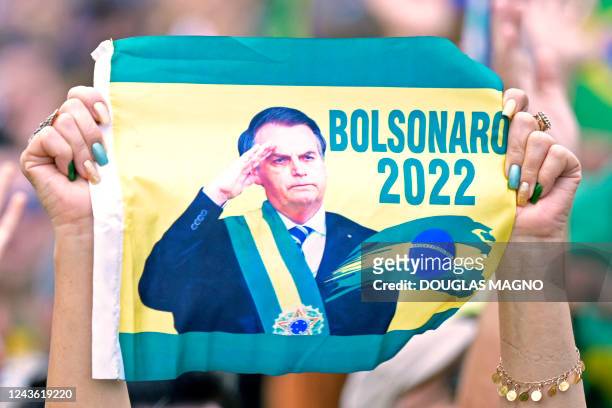 Supporter of the Brazilian President and re-election candidate, Jair Bolsonaro, holds a poster during a rally in Pocos de Caldas, Minas Gerais state,...