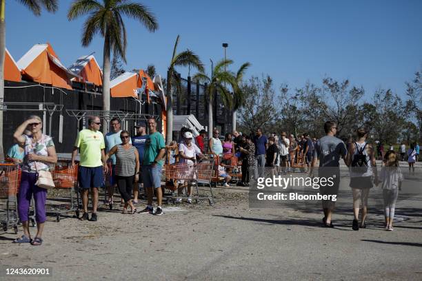Customers wait in line to enter a Home Depot store following Hurricane Ian in Cape Coral, Florida, US, on Friday, Sept. 30, 2022. Two million...