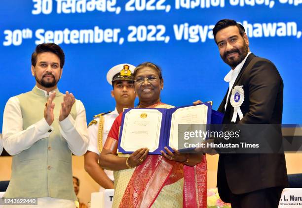 President Droupadi Murmu confers the Best Actor Award to actor Ajay Devgn at the 68th National Film Awards ceremony, at Vigyan Bhawan on September...