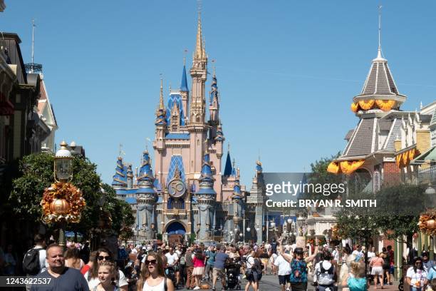 Visitors walk along Main Street at The Magic Kingdom as Walt Disney World reopens following Hurricane Ian on September 30, 2022 in Orlando, Florida....