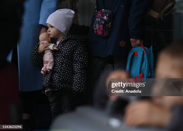 Ukrainians, going back home, wait outside the passport control office at the railway station after the annexation of 15 percent of regions of...