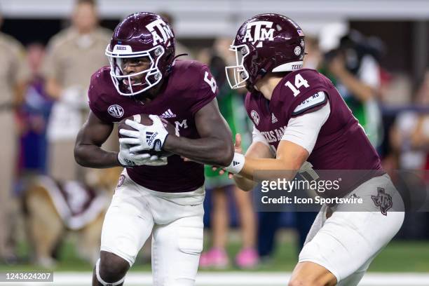 Texas A&M Aggies running back Devon Achane takes the hand-off from quarterback Max Johnson during the Southwest Classic college football game between...