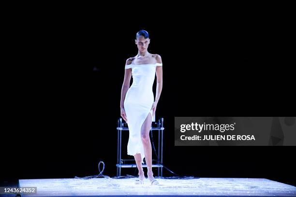 Model Bella Hadid poses in a slip dress after being sprayed with Fabrican Spray-on fabric during the Coperni Spring-Summer 2023 fashion show as part...