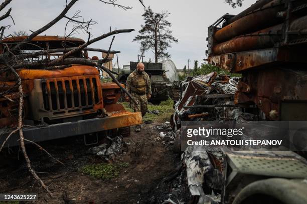 Ukrainian serviceman examines a destroyed Russian Uragan MLRS near the village of Sosnove, Donetsk region on September 30 amid the Russian invasion...