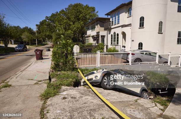 Car swallowed by a sink hole following Hurricane Ian in Orlando, Florida, US, on Friday, Sept. 30, 2022. Two million electricity customers in Florida...