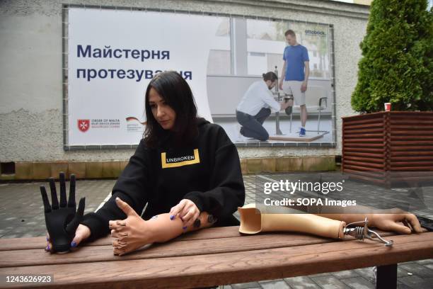 Woman demonstrates a black modern bionic hand prosthesis, an Esper Hand developed by Esper Bionics which will be fitted to Ukrainian military and...