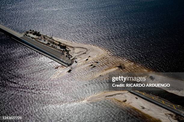 An aerial picture taken on September 30, 2022 shows the collapsed Sanibel Causeway in the aftermath of Hurricane Ian in Sanibel, Florida -...