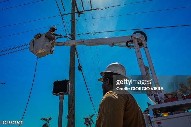 Florida Power & Light Company workers check the lines on Fort Myers Beach after Hurricane Ian on September 30, 2022. - Forecasters expect Hurricane...