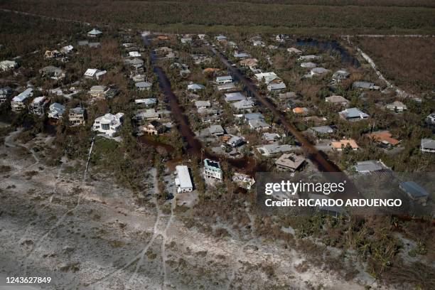 An aerial picture taken on September 30, 2022 shows damaged houses in the aftermath of Hurricane Ian in Sanibel, Florida. - Forecasters expect...