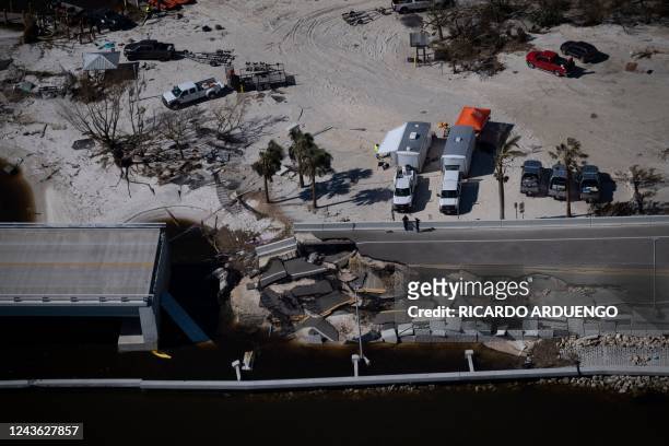An aerial picture taken on September 30, 2022 shows the collapsed Sanibel Causeway in the aftermath of Hurricane Ian in Sanibel, Florida -...