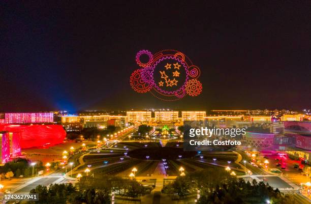 Cluster of drones performs a light show above a civic square to welcome National Day in Ordos, Inner Mongolia, China, on Sept 30, 2022.