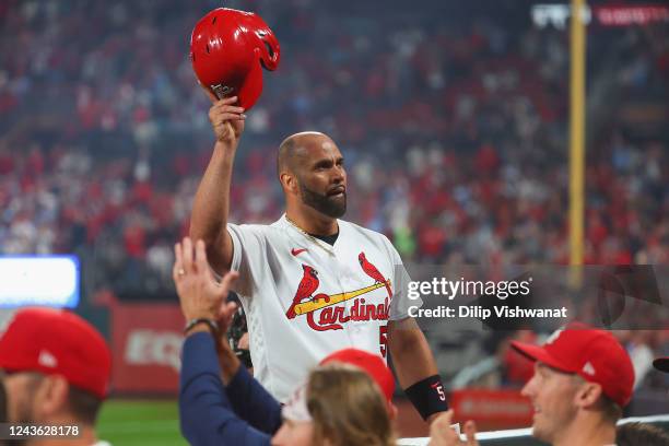 Albert Pujols of the St. Louis Cardinals takes a curtain call after hitting his 701st career home run while playing against the Pittsburgh Pirates in...