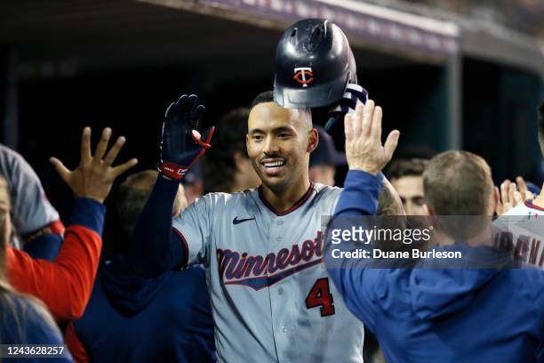 Carlos Correa of the Minnesota Twins celebrates with teammates in the dugout after hitting a two-run home run against the Detroit Tigers during the...