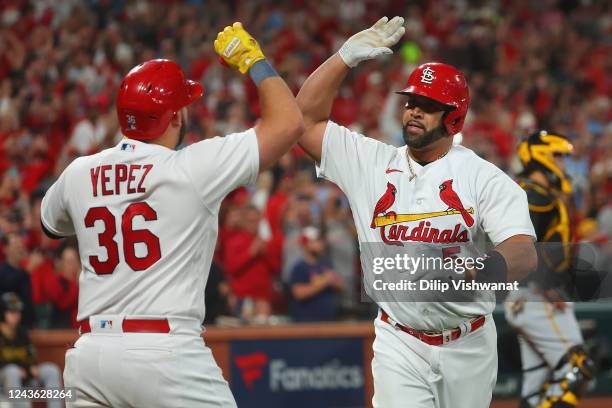 Albert Pujols of the St. Louis Cardinals is congratulated by Juan Yepez of the St. Louis Cardinals after hitting his 701st career home run while...