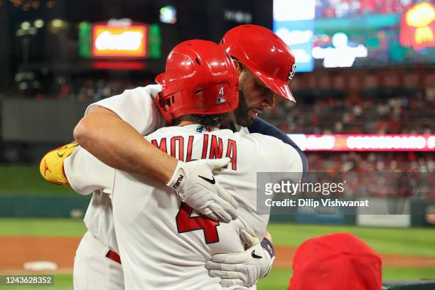 Albert Pujols of the St. Louis Cardinals is congratulated by teammate Yadier Molina after Pujols his 701st career home run while playing against the...