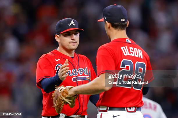 Austin Riley of the Atlanta Braves reacts with Matt Olson at the conclusion of their team's 5-2 victory over the New York Mets at Truist Park on...