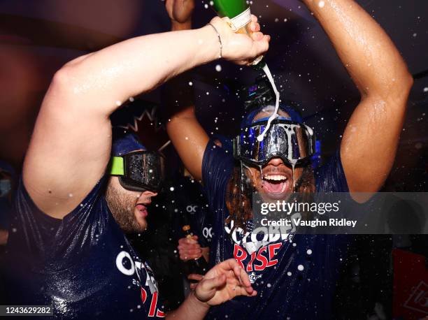 Bo Bichette and Vladimir Guerrero Jr. #27 of the Toronto Blue Jays celebrate clinching a playoff spot after the win against the Boston Red Sox at...