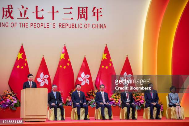 John Lee, Hong Kong's chief executive, left, speaks during a reception to celebrate National Day in Hong Kong, China, on Saturday, Oct. 1, 2022. Hong...