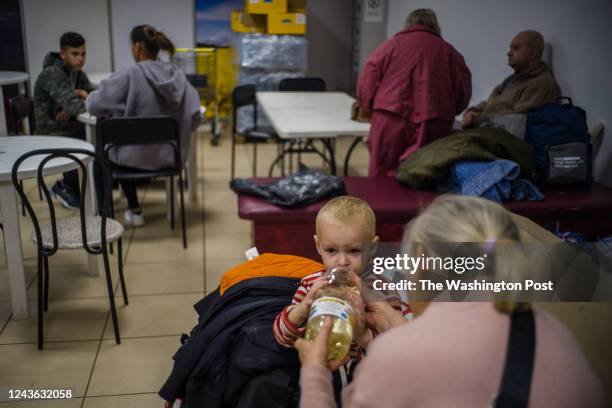 Lyda from Kahovka gives her 3yo grandson a soda in one of the help centers for internally displaced people in Zaporizhzhia, Ukraine, 30th of...