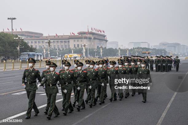 People's Liberation Army soldiers march along a road at the end of the flag raising ceremony during National Day in Beijing, China, on Saturday, Oct....