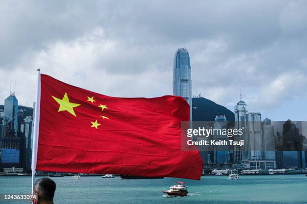 Man waves a flag of China to celebrate China National Day on October 1, 2022 in Hong Kong, China. China celebrates its National Day on October 1st...