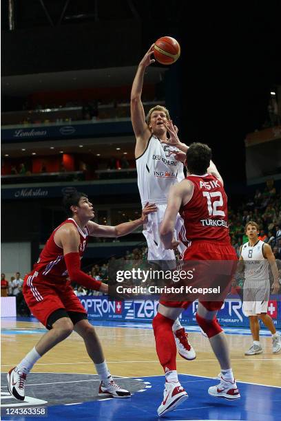 Ersan Ilyasova of Turkey and Oemer Asik of Turkey defend against Jan-Hendrik Jagla of Germany during the EuroBasket 2011 second round group E match...