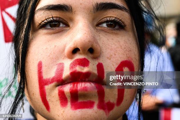 Young woman takes part in a protest on October 1, 2022 in Rome, following the death of Kurdish woman Mahsa Amini in Iran. Amini died in custody on...