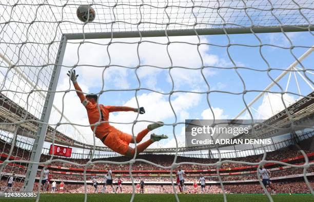 Tottenham Hotspur's French goalkeeper Hugo Lloris is beaten by Arsenal's Ghanaian midfielder Thomas Partey for the first goal during the English...