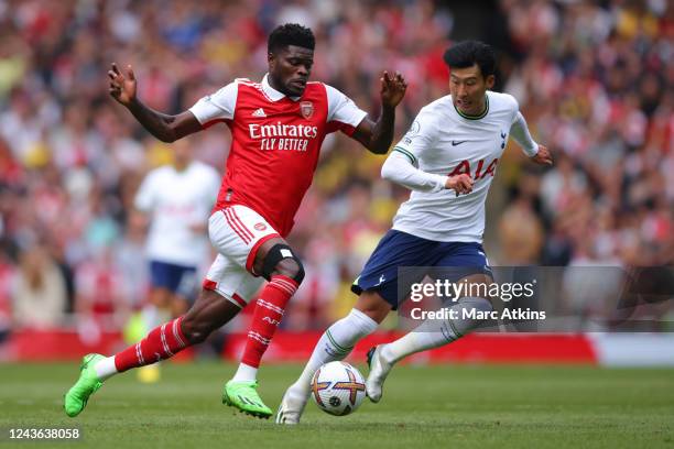 Thomas Partey of Arsenal in action with Son Heung-min of Tottenham Hotspur during the Premier League match between Arsenal FC and Tottenham Hotspur...