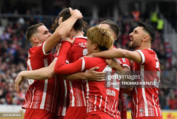 Freiburg's players celebrate their team's first goal during the German first division Bundesliga football match between SC Freiburg and Mainz 05 in...