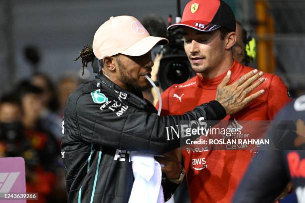 Mercedes' British driver Lewis Hamilton greets Ferrari's Monegasque driver Charles Leclerc after the qualifying session ahead of the Formula One...