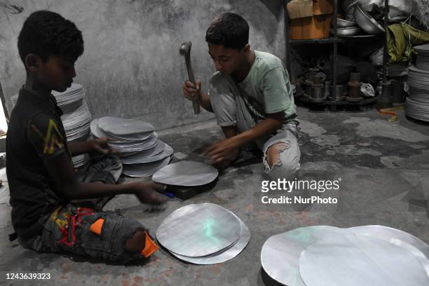 From left Shofiul and Akash , during work at a aluminium factory as they earn less than USD 10 in a week in Dhaka, Bangladesh on September 30, 2022....