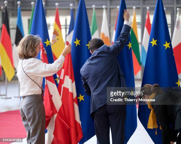 Civil servants of the EU adjust the Danish flag prior to a bilateral meeting in the Europa, the EU Council headquarter on October 1, 2022 in...