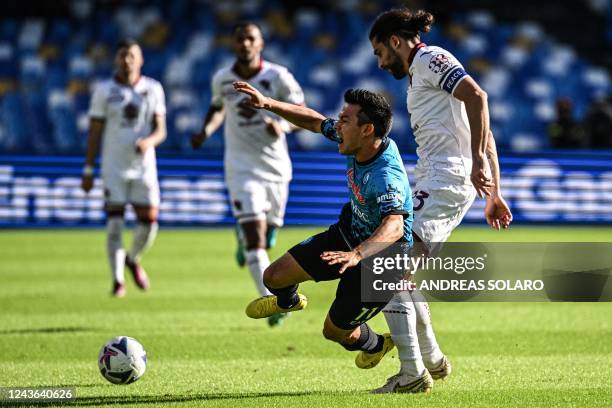 Torino's Swiss defender Ricardo Rodriguez tackles Napoli's Mexican forward Hirving Lozano during the Italian Serie A football match between Napoli...