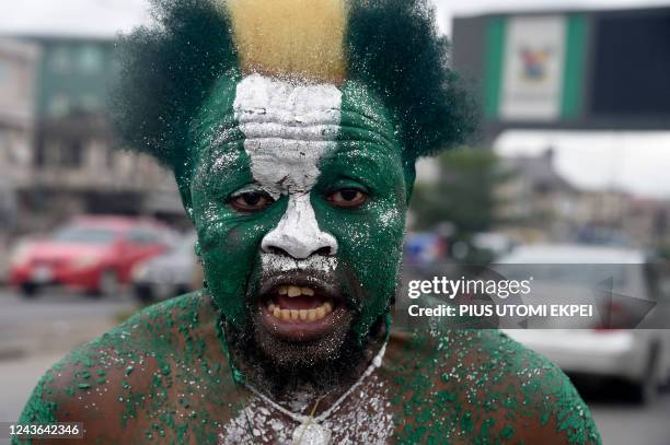 Supporter wears national green and white colours to campaign for candidate of Labour Party Peter Obi during a campaign rally in Lagos, on October 1,...