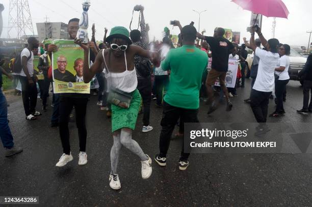 People dance in support of candidate of Labour party Peter Obi during a campaign rally in Lagos, on October 1, 2022. - Tens of thousands of...