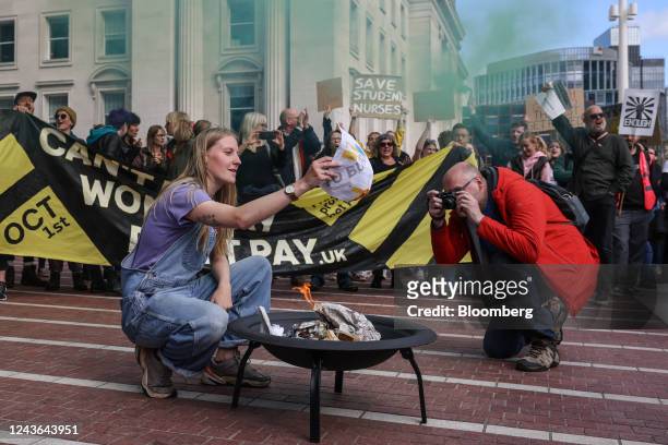 Demonstrator burns a 'Don't Pay UK' mock energy bill during a cost-of-living protest organised by the Enough is Enough campaign in Birmingham, UK, on...