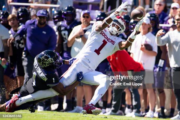 Wide receiver Jayden Gibson of the Oklahoma Sooners is brought down by cornerback Tre'Vius Hodges-Tomlinson of the TCU Horned Frogs while attempting...