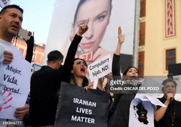 Protesters attend a demonstration in support of Kurdish woman Mahsa Amini on October 1, 2022 in Madrid, following her death in Iran. - Protest...