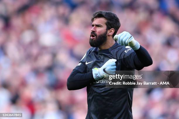 Alisson Becker of Liverpool celebrates during the Premier League match between Liverpool FC and Brighton & Hove Albion at Anfield on October 1, 2022...