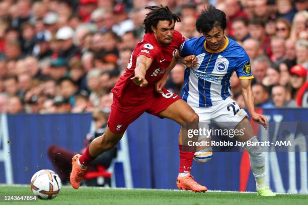 Trent Alexander-Arnold of Liverpool tussles with Kaoru Mitoma of Brighton & Hove Albion during the Premier League match between Liverpool FC and...